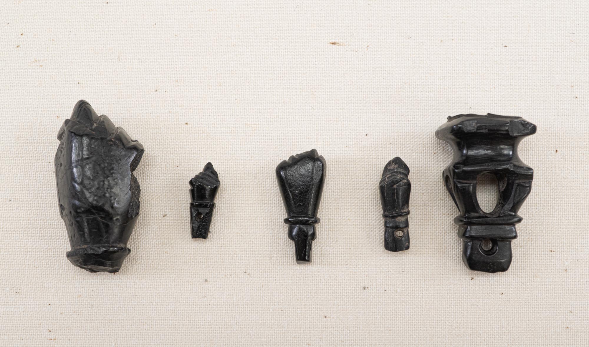 These items are mano fica amulets from the site of Presidio La Bahia on Garcitas Creek.